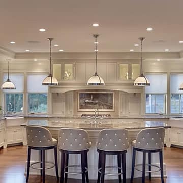 Bright custom kitchen remodel with white cabinetry, island and quartz countertops