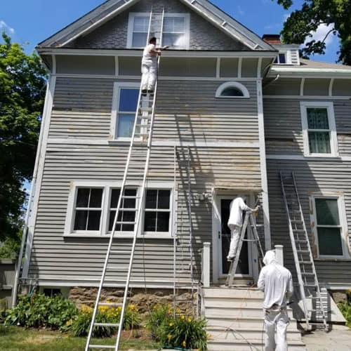 All American Remod crew painting the exterior of a Michigan home