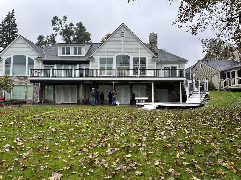 Home with a large premium composite deck extending across the back exterior