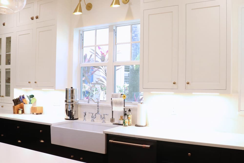Modern kitchen design with white quartz countertops and brass hardware, addressing the question How Much Does a Kitchen Remodel Cost.