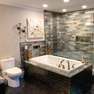 modern bathroom remodel, traditional bathroom remodel Luxury bathroom remodel featuring a tiled walk-in shower, soaking tub with bronze fixtures, and modern tilework.